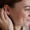 model wearing gold pebble hoop earrings