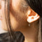 model wearing gold safety pin hoop earrings