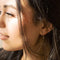 model wearing gold safety pin hoop earrings