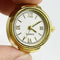 up close of model holding gold watch ring