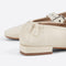 up close of elastic back of creme mary jane flats