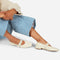 model wearing creme mary jane flats with elastic back and thick buckle strap with silver grommets and buckle