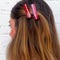 model wearing two bacon strip hair clips