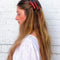 model wearing two bacon strip hair clips