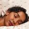 model using light pink silk pillowcase with brown dainty crown print