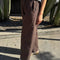 side view of model wearing brown cotton relaxed pants