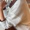 side view of model wearing pearl white mohair cardigan