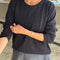 model wearing black long sleeve cotton tee