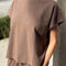 model wearing chocolate relaxed fit cotton tee with muscle type sleeves and side vents