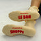 red lettered bottom of model wearing light yellow ruffle socks