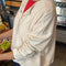side view of model wearing naturel snap front cotton cardigan