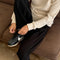 up close of model wearing black waffle knit pants with elastic waist and side pockets