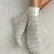 model wearing white socks with thin sky blue stripes