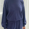 model wearing navy pointelle sweatshirt with banded bottom