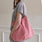 model carrying red and white gingham rectangular bag