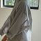 side view of model wearing white relaxed fit button front shirt with side vents, collar and denim blue stripes