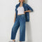 model wearing blue cropped button jeans with white bleach splatters