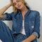 model wearing blue relaxed fit chore jacket with faint pinstripes, white bleach splatters and patch pockets