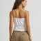 back view of model wearing white cami tank with ruffle trim, button front and tie waist