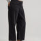 side view of model wearing black loose crop button fly jeans