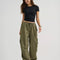 model wearing green low rise parachute cargo pants with ruched bottoms