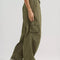 side view of model wearing green low rise parachute cargo pants with ruched bottoms