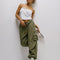 model wearing green low rise parachute cargo pants with ruched bottoms