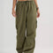 model wearing green low rise parachute cargo pants with ruched bottoms