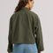 back view of model wearing olive green cropped utility jacket with large patch pockets on the front