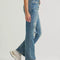 side view of model wearing classic straight leg jeans with medium gritty wash with distressing on the knees