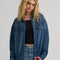 model wearing dark denim relaxed shit button down shirt with patch pockets in the front
