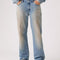 up close of model wearing medium denim wash with tan wash on the legs