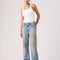 model wearing medium denim wash with tan wash on the legs