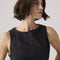 up close of model wearing black denim peplum tank top
