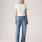 model wearing light denim 90's ankle jeans