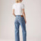 back view of model wearing light denim 90's ankle jeans