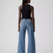 back view of model wearing light denim low loose jeans
