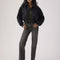 model wearing black wash relaxed straight leg jeans