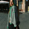model wearing kelly green and pink striped cardigan with gold bow buttons with matching bonnet and scarf