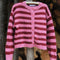 hanging textured cardigan with red and pink horizontal stripes