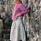 side view of model wearing mint asymmetrical dot midi skirt with purple cardigan