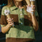 up close of model wearing brown and mint striped short sleeve polo sweater