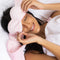 model wearing pale pink and white stripe weighted eye mask