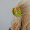 up close of model wearing oversized green olive hair claw