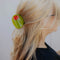 model wearing oversized green olive hair claw