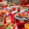 completed puzzle of 'tomato tomahto' 1000 piece puzzle with various tomato items on a red tiled table