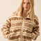model wearing cropped white zip up jacket with brown alpine print