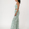 side view of model wearing mint wide leg pants with dainty blueberry vine print and matching cropped tank