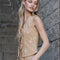 side view of model wearing sand vest with lace detail, embroidered daisy print and tie front