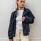 model wearing oversized high neck denim cropped jacket
